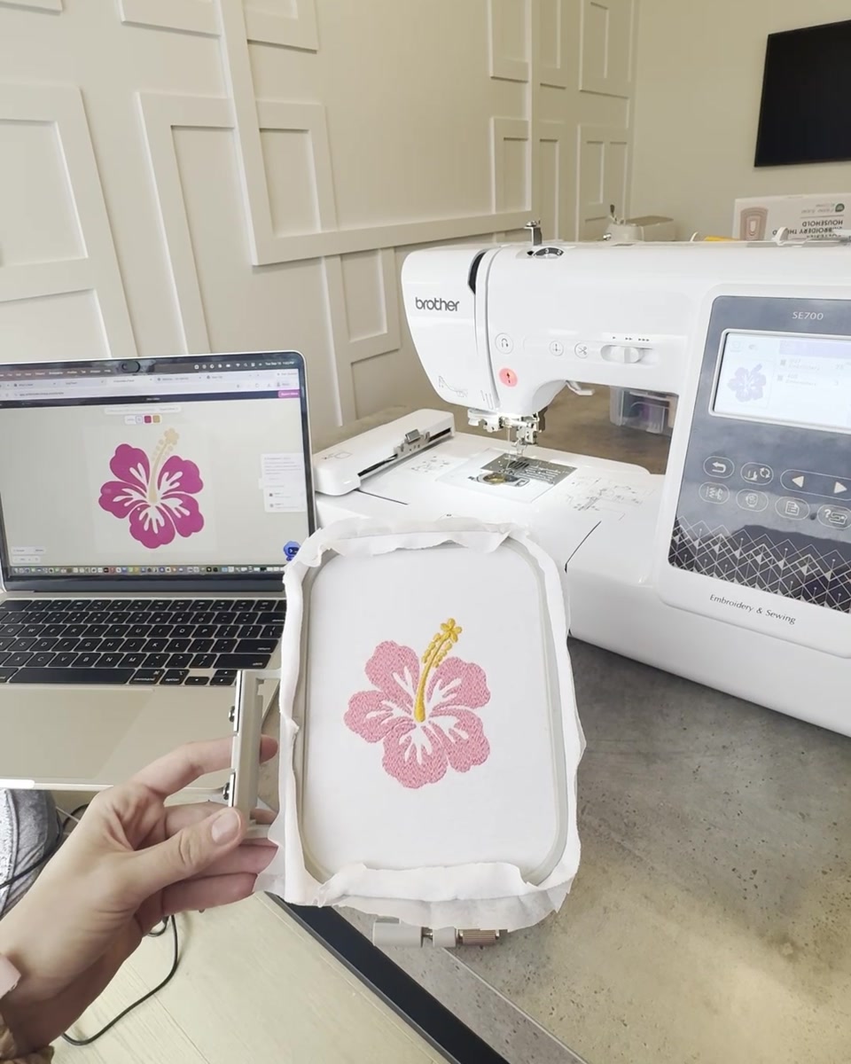 The matching hibiscus design embroidered on white fabric.